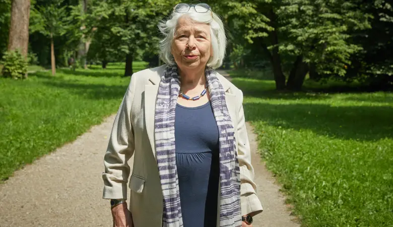 Eine Frau geht in einem Park spazieren. 